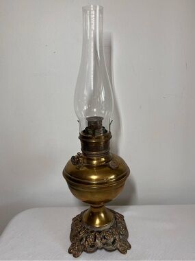 Vintage brass kerosene oil lamp, 1910, ornate cast iron base, glass chimney, USA